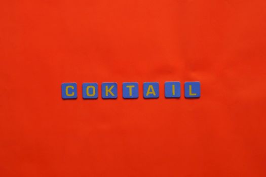 Blue and yellow letters spelling 'Coktail' on a vibrant orange backdrop, perfect for creative projects.