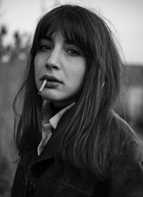  Woman Smoking a Cigarette in Grayscale Photography