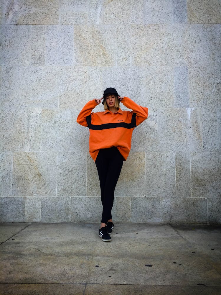 Young Woman In Casual Clothing On A Sidewalk 