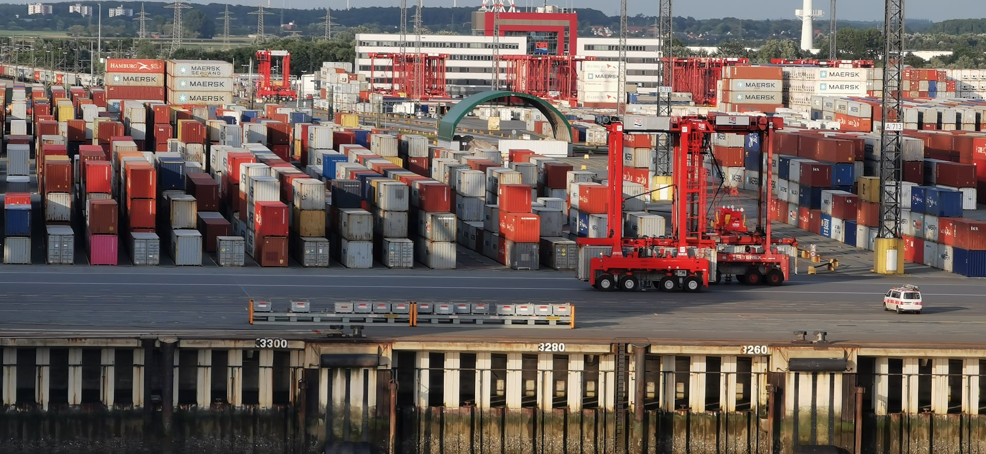 Aerial view of shipping containers at Bremerhaven port, Germany. Seaport with container storage and cranes.