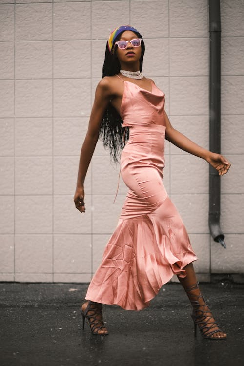 Photo of Woman in Pink Spaghetti Strap Top and Pink Long Skirt