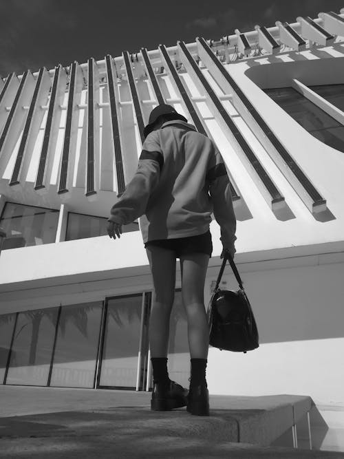 Free Grayscale Photo of a Woman Carrying a Black Handbag Stock Photo