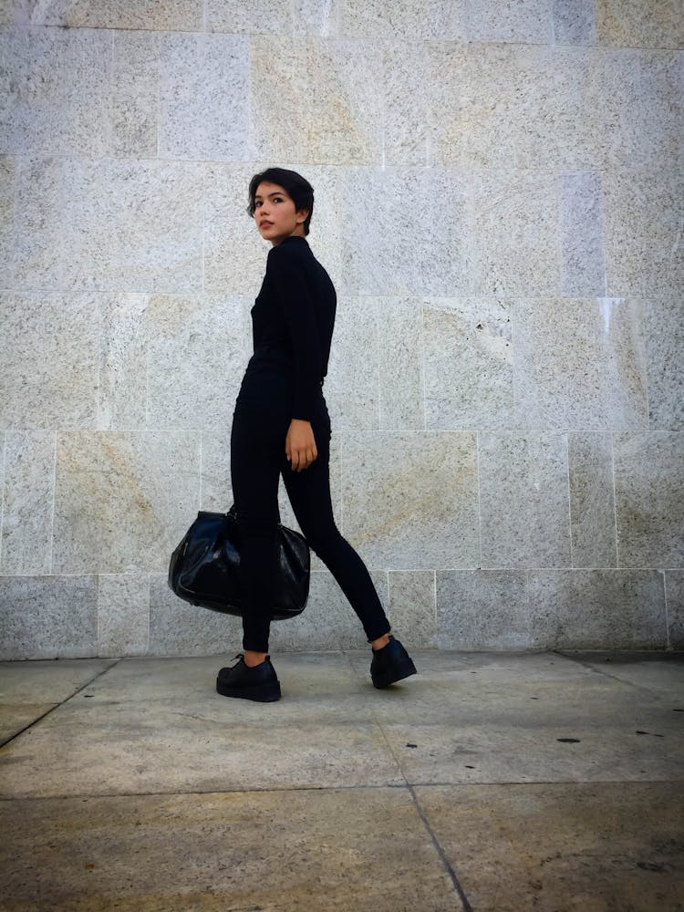 Person Carrying A Black Leather Bag