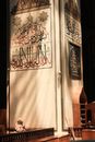 Brown Acoustic Guitar Beside White Wooden Door