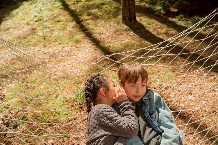 A Girl Telling A Boy A Secret