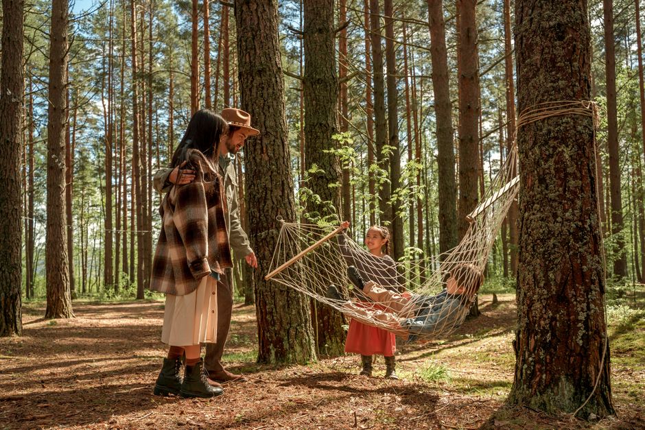 family enjoying outdoor camping with treehouse