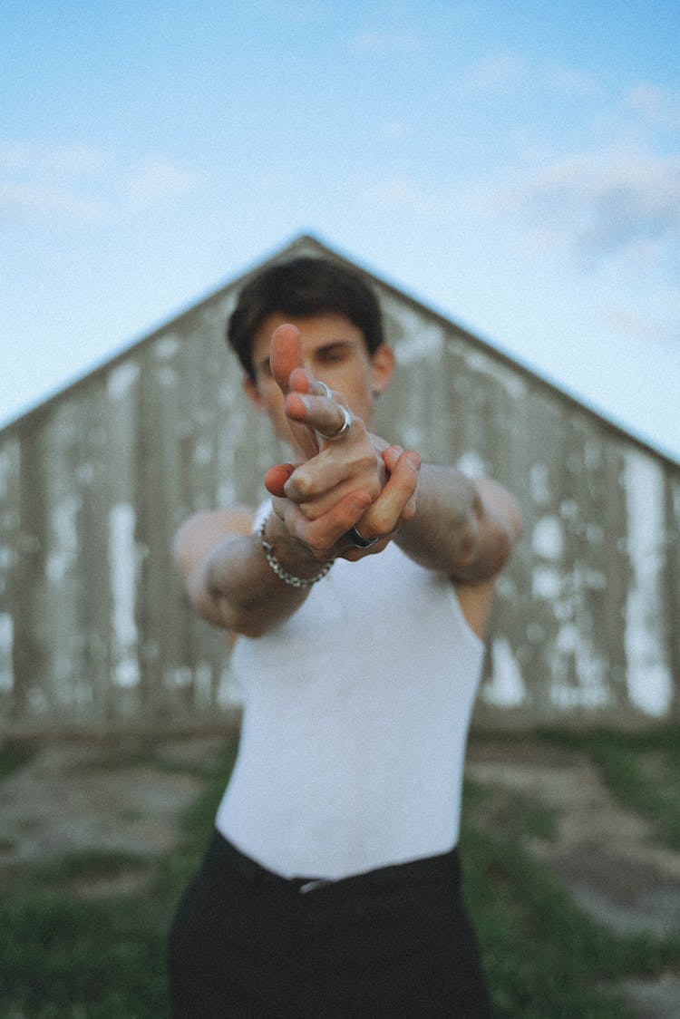 Man In White Tank Top Pointing His Fingers