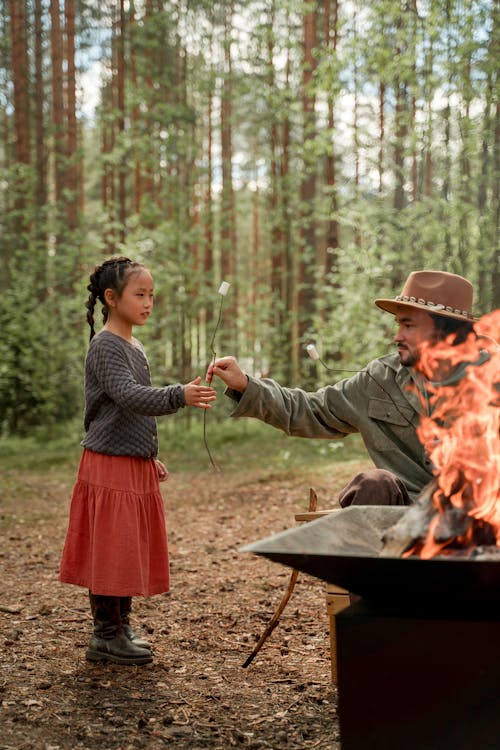 Father giving Marshmallow to his Daughter 