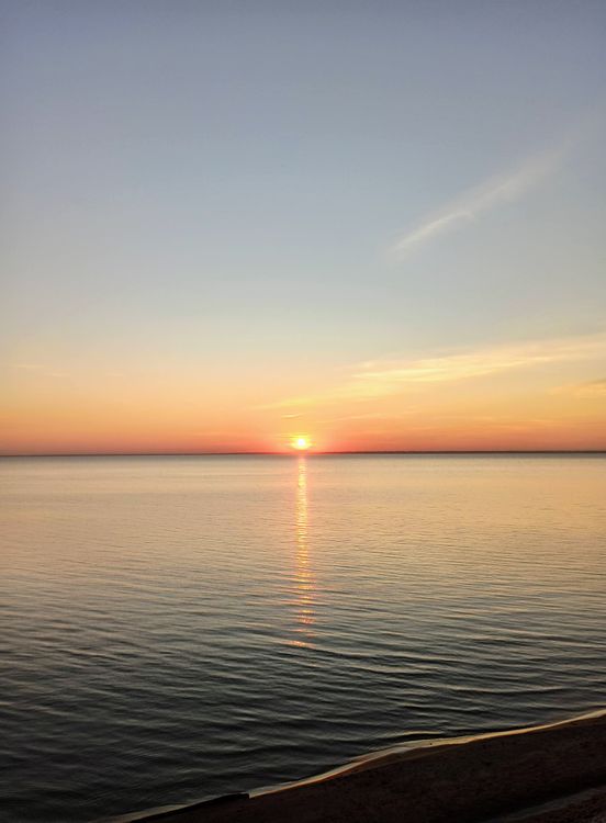 Calm Sea Setting A Sun Setting Over a Calm Sea · Free Stock Photo