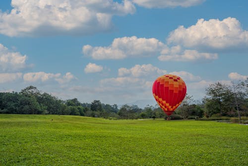  Hot Air Balloon Flying on Green Grass Field