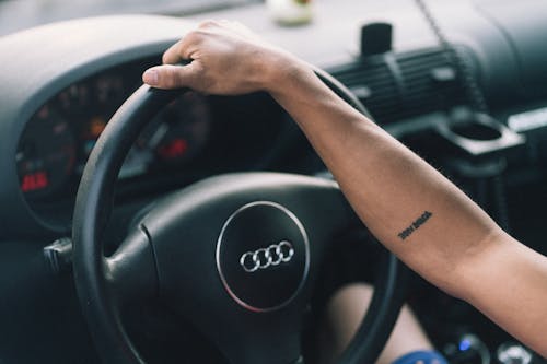 Person Holding Black Steering Wheel