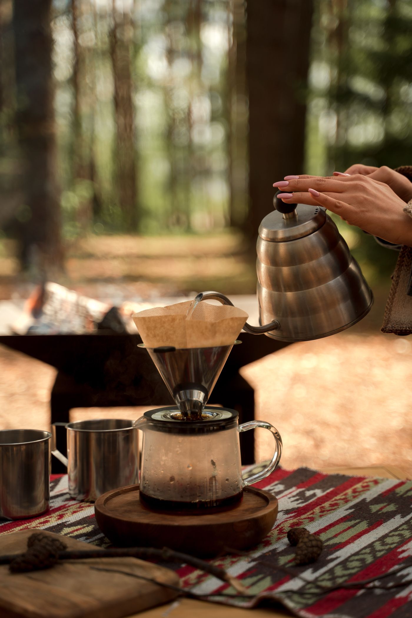 Fresh pour-over coffee being prepared by hand with a kettle and coffee dripper