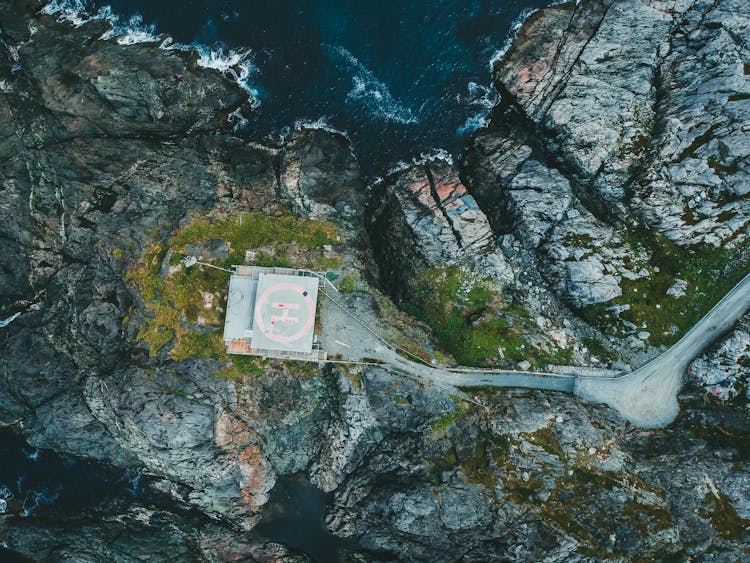 

An Aerial Shot Of A Helipad On A Rocky Mountain