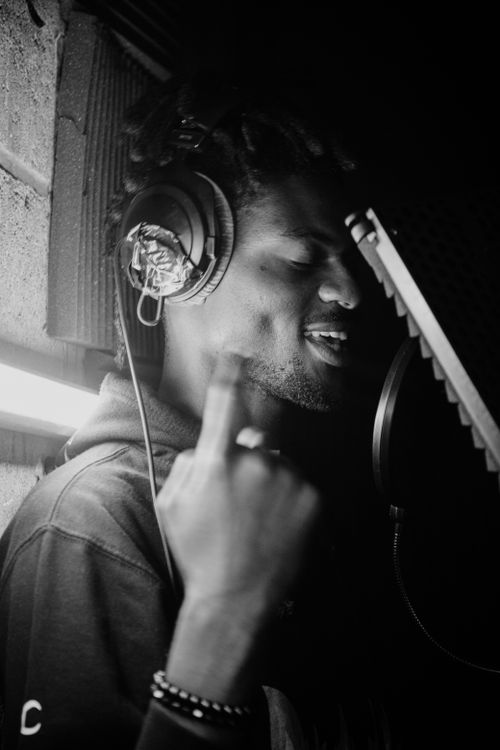 Free Artistic black and white photo of a male singer in recording studio. Stock Photo