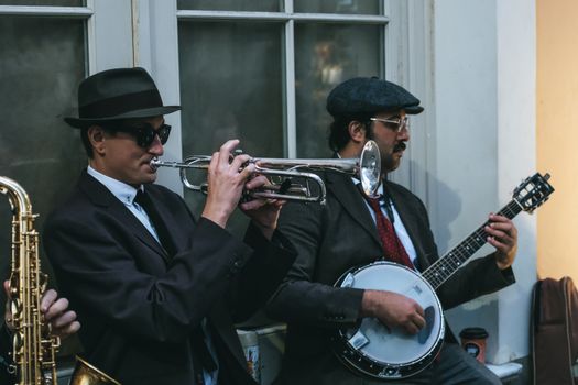 Men in Black Suits Playing Musical Instruments