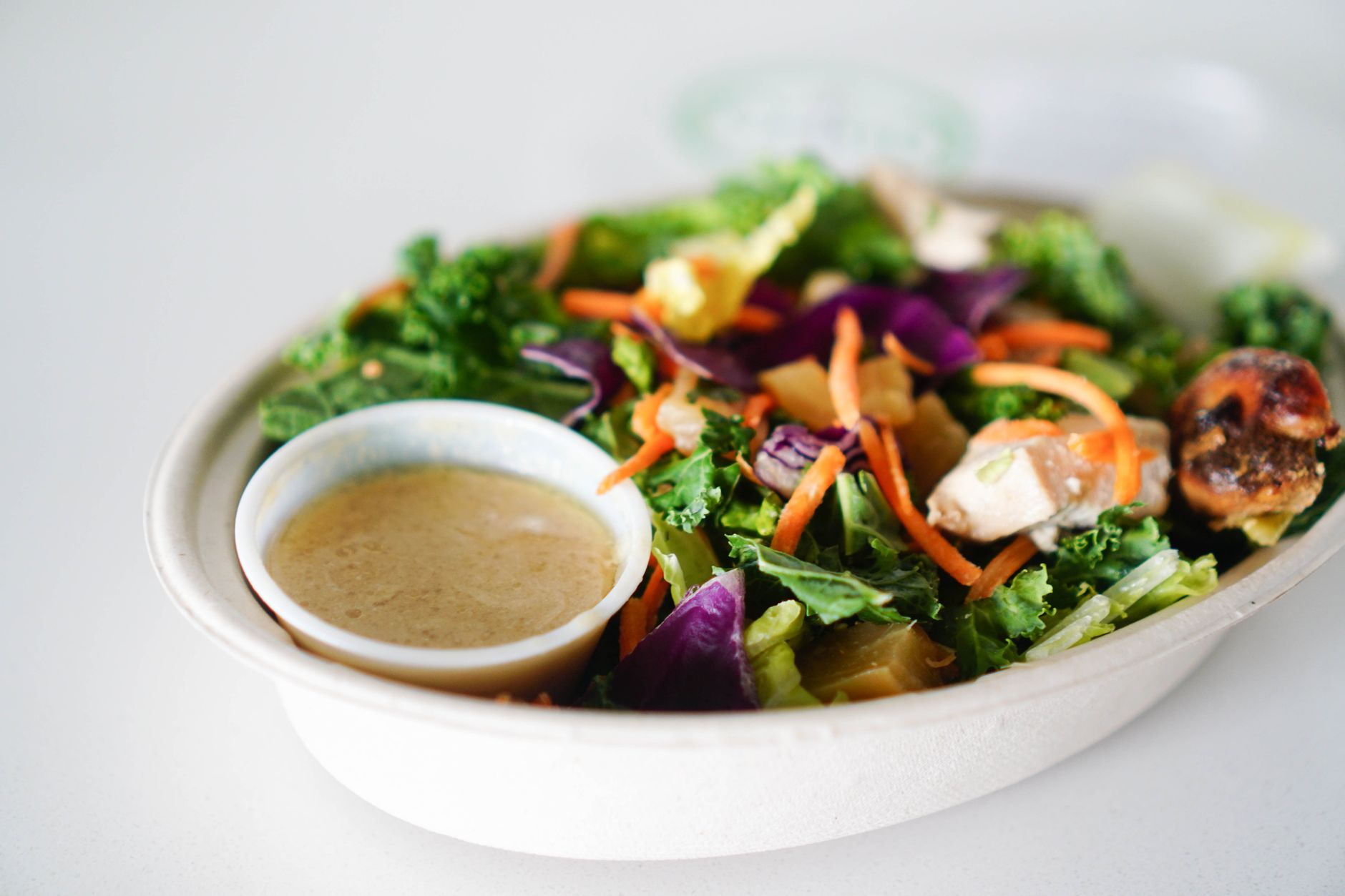 Quick Vegan Sweet Potato Chickpea Taco Salad Recipe A vibrant close-up of a healthy salad with dressing, perfect for a light meal.