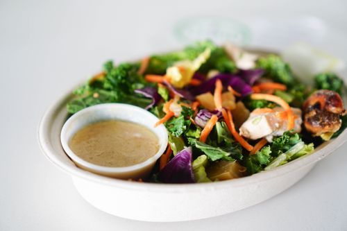 Free A vibrant close-up of a healthy salad with dressing, perfect for a light meal. Stock Photo