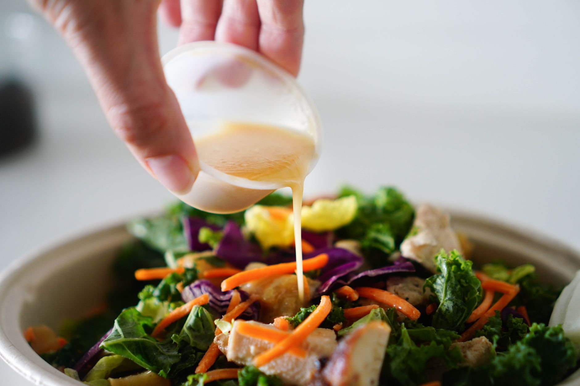 Quick Vegan Sweet Potato Chickpea Taco Salad Recipe A delicious and healthy salad topped with fresh dressing being poured from a cup.