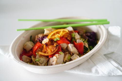 Free Hearty salad with chicken, vegetables, and citrus in a bowl with chopsticks. Stock Photo
