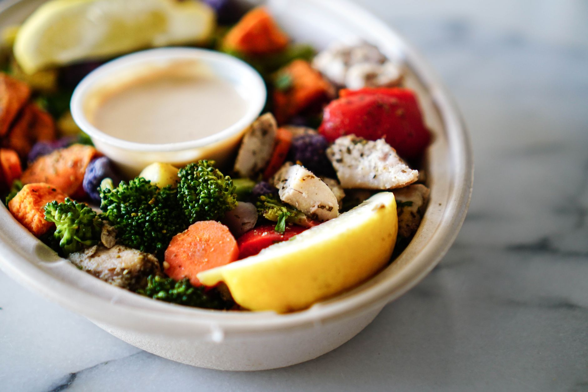 Creamy lemon red pepper aioli in a bowl with roasted red peppers