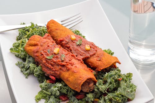 Crispy Fried Food on White Ceramic Plate with Green Vegetables
