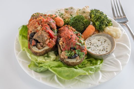 Delicious gourmet stuffed potatoes served with mixed vegetables and a creamy dip.