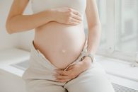 A Pregnant Woman in White Top and White Pants