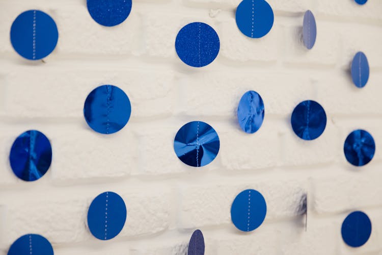 Decorations Made Of Blue Glossy Paper On White Wall