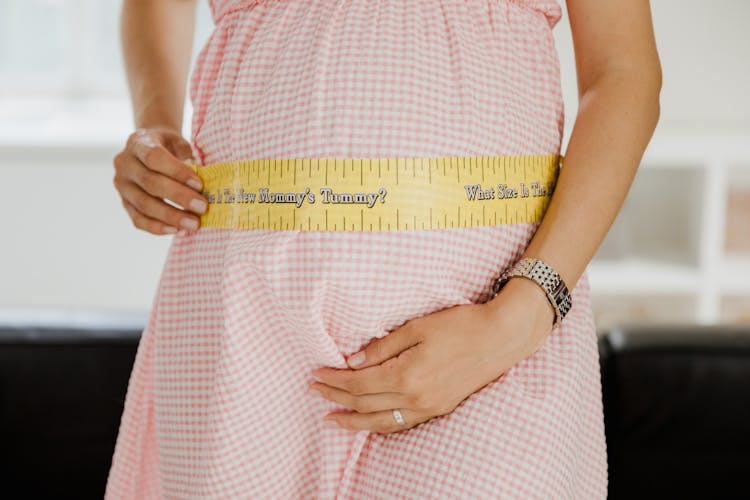 Pregnant Woman Measuring Her Belly