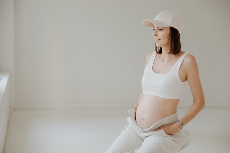 Pregnant Woman Sitting Down With Unzipped Pants