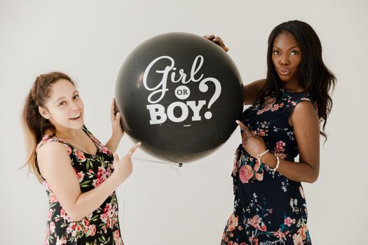 Woman in Black Pink and White Floral Dress Holding Black Happy Birthday Balloon