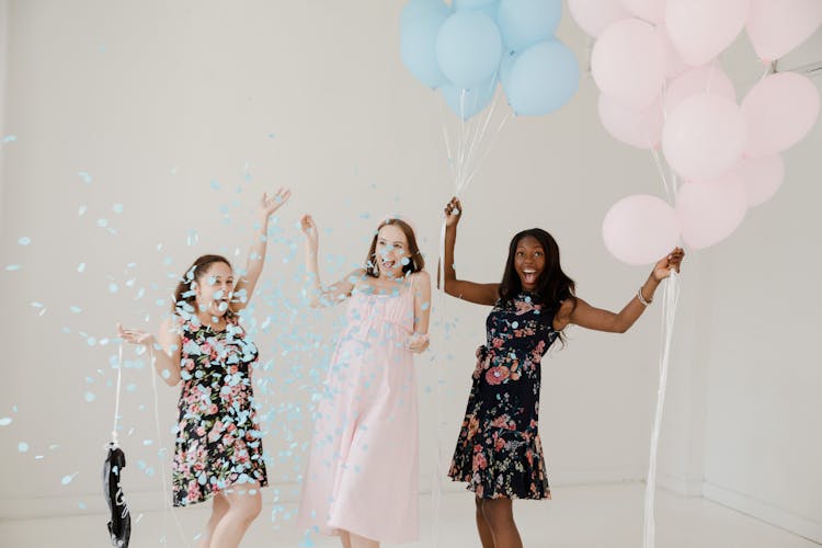 Women Celebrating At A Gender Reveal Party 
