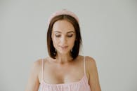 Woman in Spaghetti Strap Top Wearing Headband Looking Down