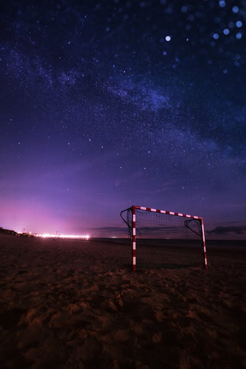 Brown Wooden Ladder on Brown Sand Under Starry Night