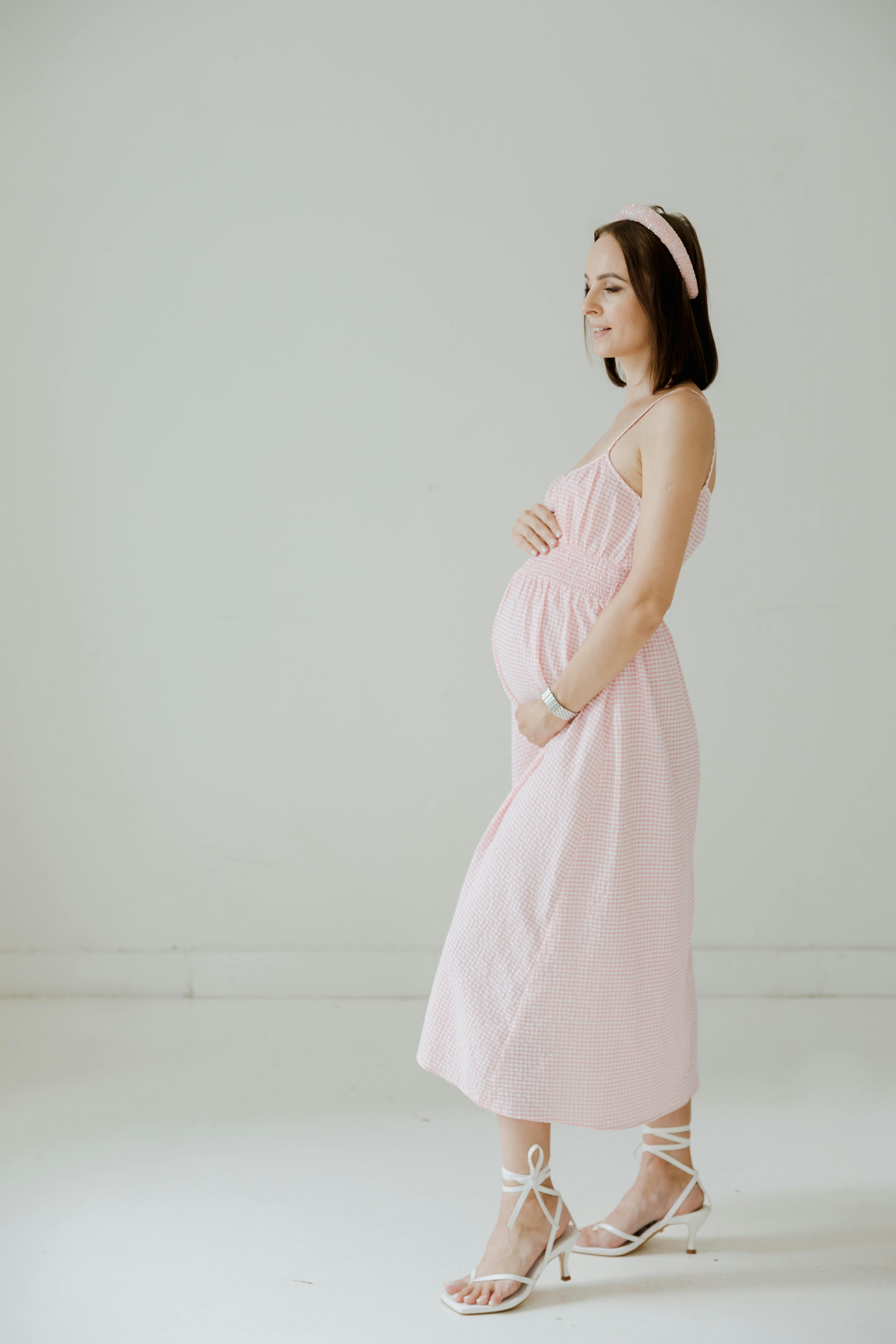 pregnant woman in pink sleeveless dress