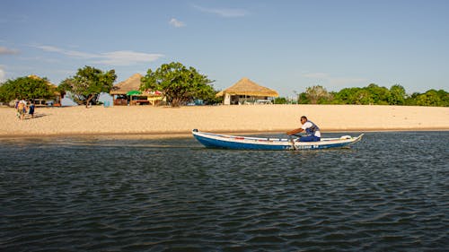 Free Man riding a Kayak on Beachside  Stock Photo