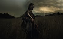 Woman in Black Hoodie Standing on Grass Field