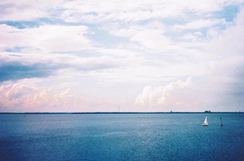 Free Blue Ocean Water Under White Clouds Stock Photo