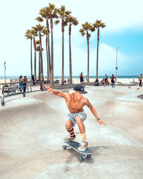 Man in Shorts Riding a Skateboard