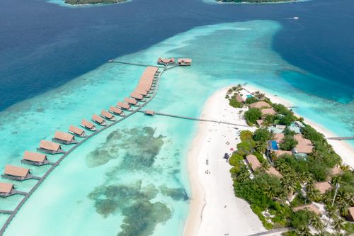 Free A breathtaking aerial view of overwater bungalows and pristine beaches in Kaafu Atoll, Maldives. Stock Photo