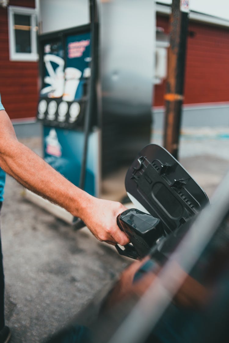 Man Pouring Gas Into Vehicle Gasoline Tank