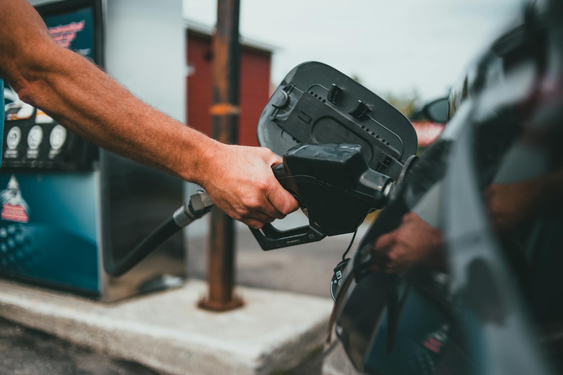 Person Putting Gasoline on a Vehicle