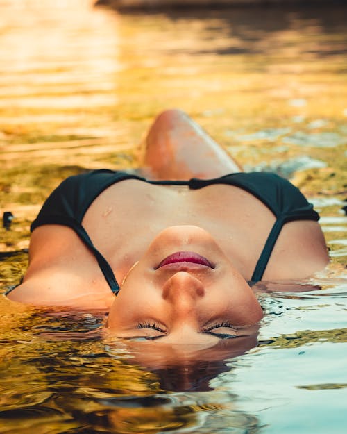 Close Up Photo of Woman in Black Bikini Top