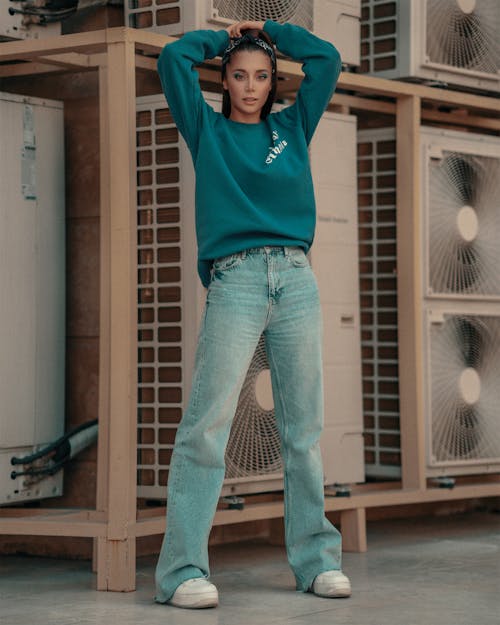 Woman Wearing a Sweater and Denim Jeans
