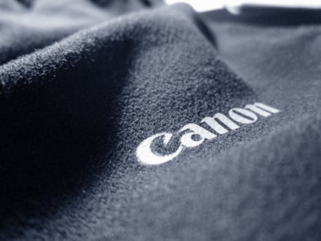 A detailed close-up of a black fabric with embroidered text, showcasing texture and material quality.