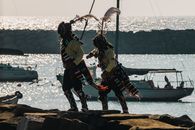 Colorful traditional dancers perform by the sea in Arica, Chile.