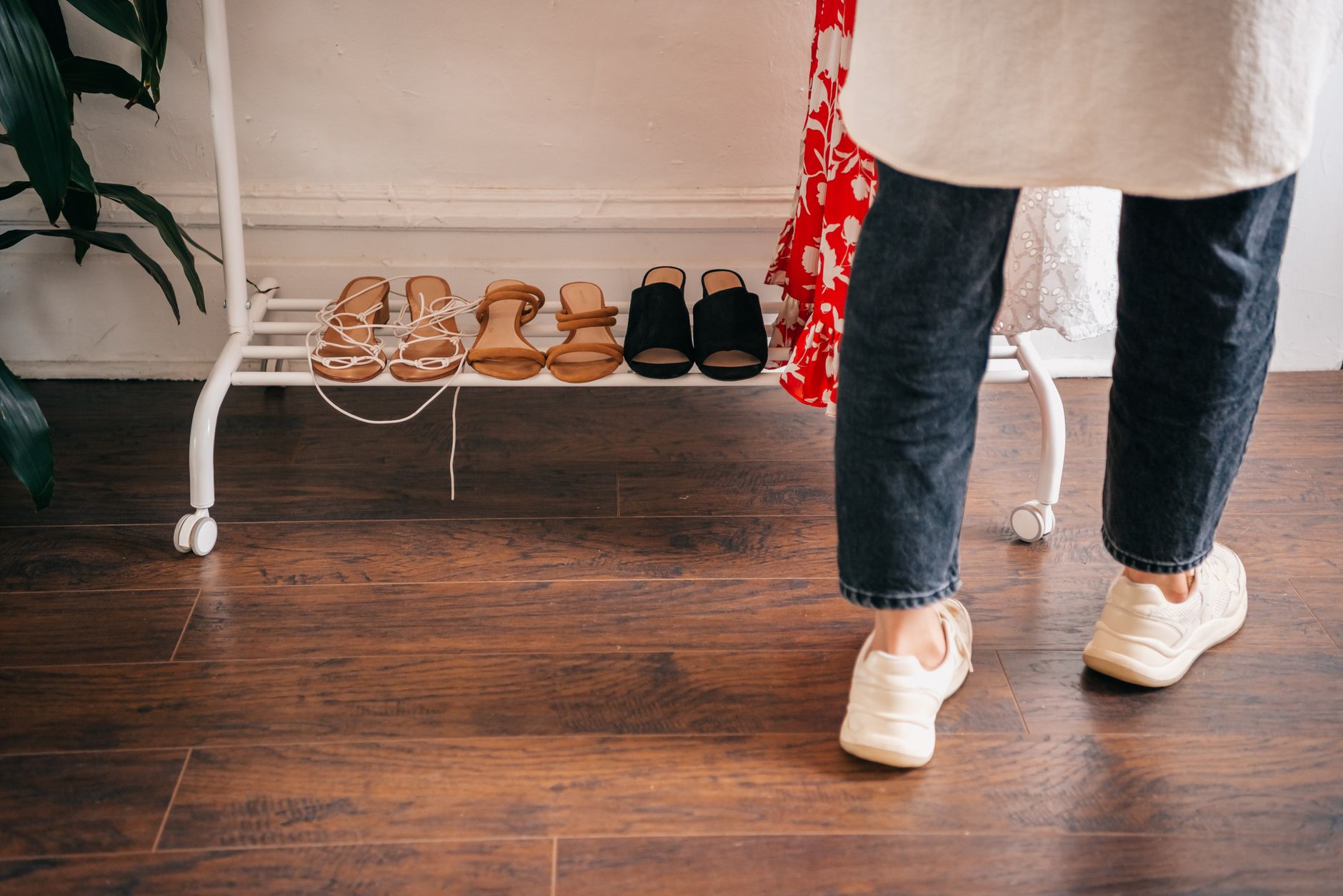 A collection of different floor stands including lighting, clothing racks, and studio equipment arranged neatly.