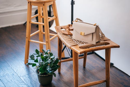 Brown Bag on Brown Wooden Chair