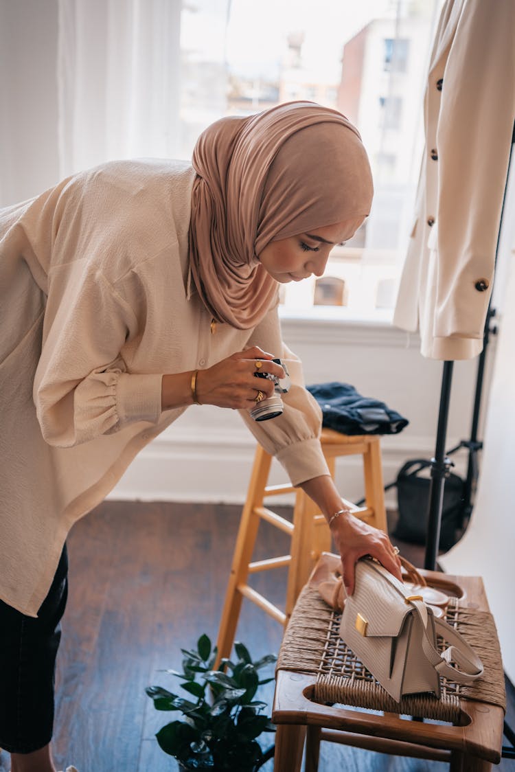 Woman Wearing Hijab Taking Photo Of A Bag