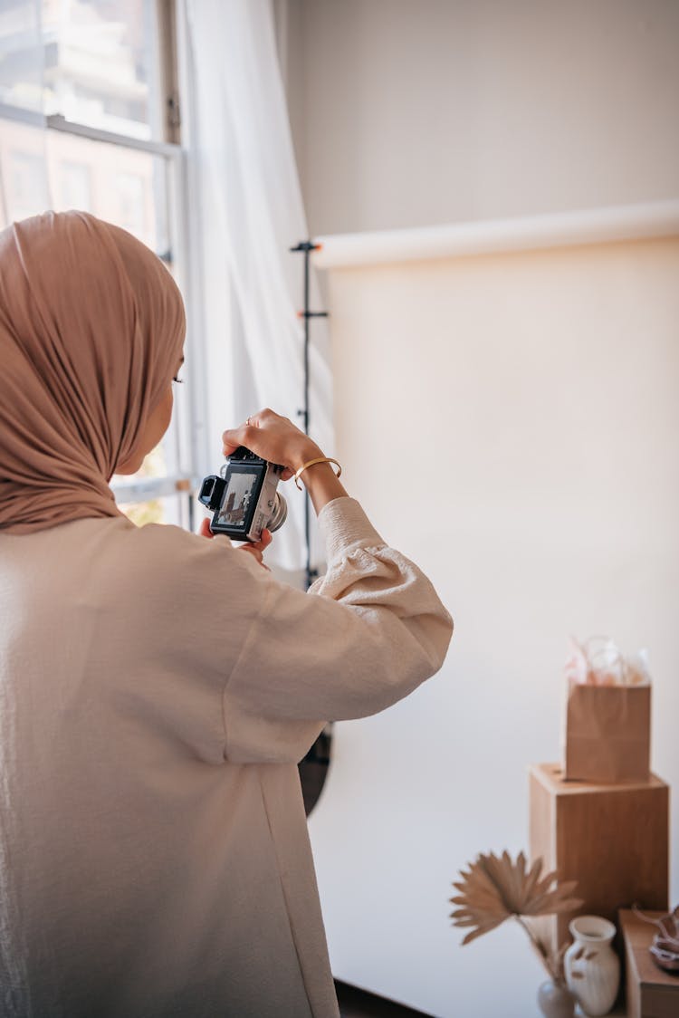 A Woman With A Hijab Looking At A Camera